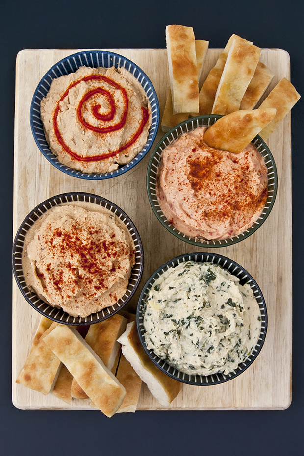 A hummus flight is perfect for your next party or potluck. Get the recipes for chipotle feta hummus, spinach artichoke hummus, roasted red pepper hummus, and spicy hummus
