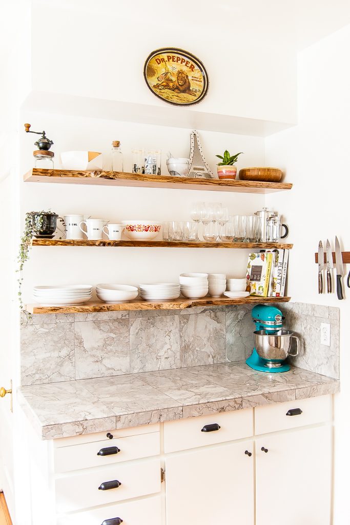Kitchen makeover featuring white cabinets, and open shelving with live-edge floating shelves. #kitchen #openshelves #DIY #openshelving
