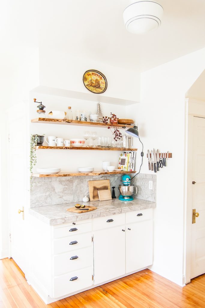 Kitchen makeover featuring white cabinets, and open shelving with live-edge floating shelves. #kitchen #openshelves #DIY #openshelving