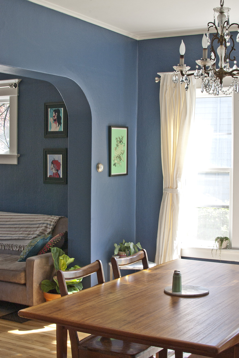Dark blue dining room/living room with complementary colors