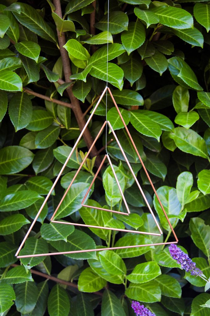 Make a copper triangle mobile, then hang it either indoors or outside.