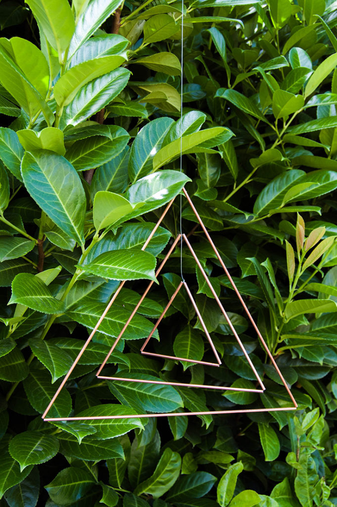 Make a copper triangle mobile, then hang it either indoors or outside.