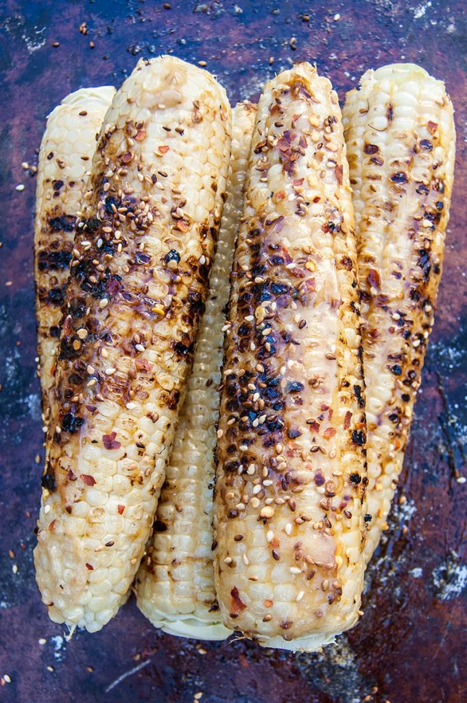 Caramelized honey miso butter grilled corn is a delicious twist on a summer barbecue staple. #miso #corn #grill #grilling #summer #recipe
