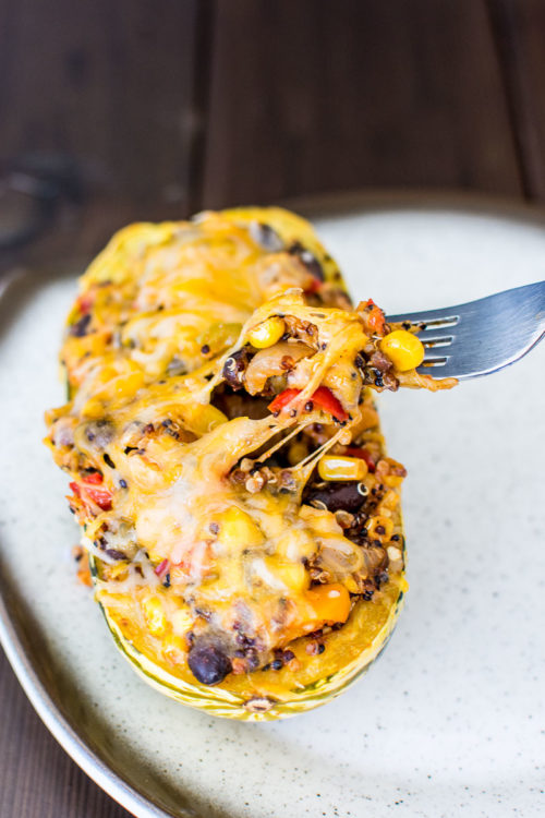 Delicata Squash Stuffed with Tex-Mex Veggie Quinoa - This flavorful vegetarian dish is loaded with healthy vegetables, but tastes more like a burrito than health food.