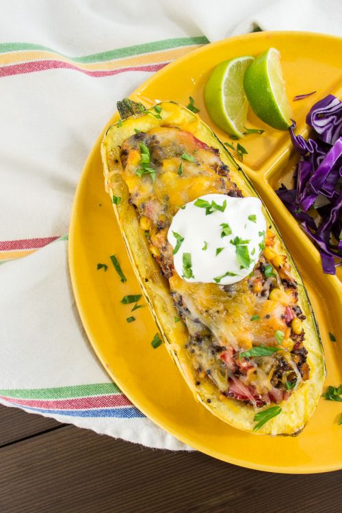 Delicata Squash Stuffed with Tex-Mex Veggie Quinoa - This flavorful vegetarian dish is loaded with healthy vegetables, but tastes more like a burrito than health food.