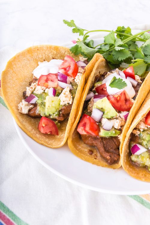 Make these mushroom mole black bean tacos in the slow cooker for an easy, flavorful vegan meal. 