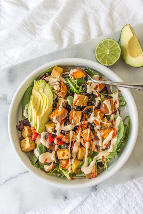 Roasted sweet potatoes and black beans topped with a creamy cashew lime dressing make this vegan salad refreshing and satisfying. #vegan #salad #lunch