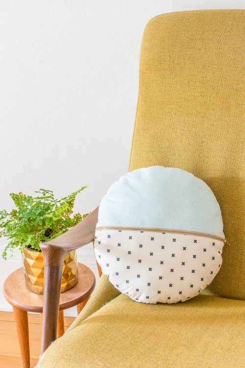 This DIY round pillow with exposed zipper is a fun way to play with pattern and color, and use up scraps of cute fabric! #DIY #sewing #homedecor #tutorial #pillow #cushion